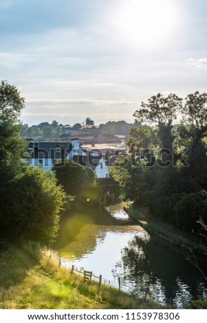 Sunset view British rural landscape scene with river near Northampton