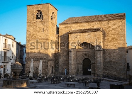 Sunset view of the church of San Nicolas with hospitality terrace in the village of Plasencia, Spain