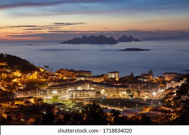 Sunset view of the city of Baiona with the silhouette in the background of the Cies islands in Galicia, Spain.