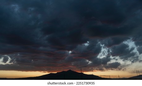 sunset view and cloudy sky with dramatic clouds, sunset over mountains