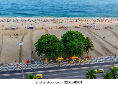 Sunset view of Copacabana beach and Avenida Atlantica in Rio de Janeiro, Brazil. Copacabana beach is the most famous beach of Rio de Janeiro. Skyline of Rio de Janeiro.