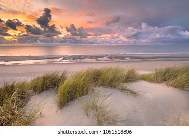 Sunset View from dune top over North Sea and Canal in Zeeland, Netherlands