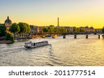 Sunset view of Eiffel tower, Pont des Arts and Seine river in Paris, France. Eiffel Tower is one of the most iconic landmarks of Paris. Architecture and landmarks of Paris. 