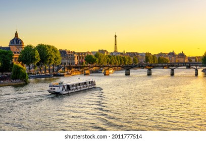 Sunset view of Eiffel tower, Pont des Arts and Seine river in Paris, France. Eiffel Tower is one of the most iconic landmarks of Paris. Architecture and landmarks of Paris. 