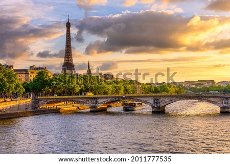 Sunset view of Eiffel tower and Seine river in Paris, France. Eiffel Tower is one of the most iconic landmarks of Paris. Architecture and landmarks of Paris. 