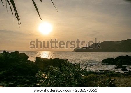 A sunset view featuring rock formations at Menganti Beach, Central Java.