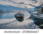 Sunset view from Bostanlı fishing port. Izmir city and Izmir gulf. Port city on the Aegean Sea.