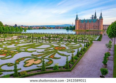 Sunset view of gardens of Frederiksborg Slot palace in Denmark.