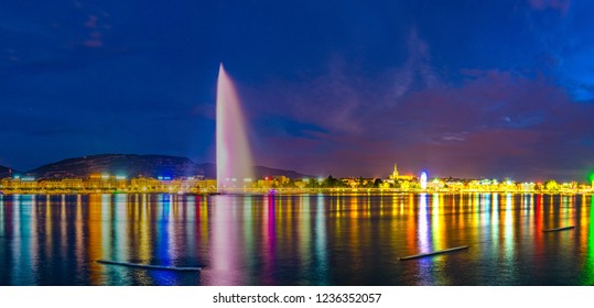 Sunset view of Geneva dominated by Jet d'eau fountain and Saint Pierre Cathedral, Switzerland