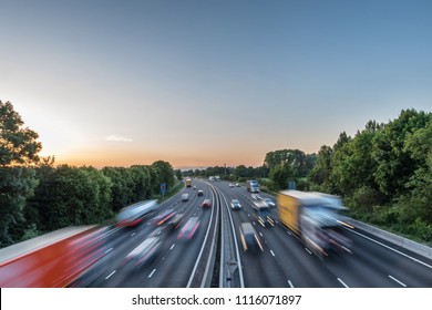 Sunset view heavy traffic moving at speed on UK motorway in England