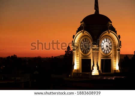 Sunset view of the historic clock tower in downtown Santa Ana, California, USA.