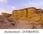 Sunset view of the Masada Marls rocks formation (Havarey Masada), between Masada fortress and the Dead Sea, Judaean Desert, southern Israel