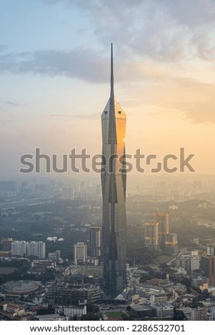Sunset view of Merdeka tower with golden hour light.