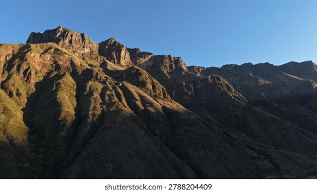 Sunset view of a mountain range slope during the sunset. 