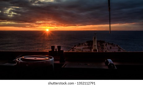 Sunset view from navigation bridge window of super tanker