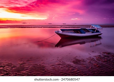 Sunset view at Nunsui Beach features a traditional wooden boat against a backdrop of reddish-purple hues. The sky's colors reflect beautifully on the calm sea, creating a serene and picturesque scene. - Powered by Shutterstock