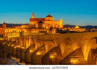 Sunset view of the old roman bridge in the spanish city cordoba with the la mezquita cathedral on horizon - Shutterstock ID 2270737835