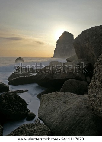 Sunset view on the rocky beach called Pangasan beach in Pacitan, East Java, Indonesia