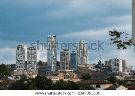 Sunset view over buildings in capital city of Tegucigalpa, while are illuminated by a red sunlight