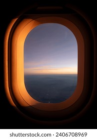 Sunset view over the clouds from an airplane window