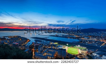 Sunset view over Gibraltar - a British Overseas Territory, and Spanish town of La Líinea de la Concepcion on Bay of Gibraltar