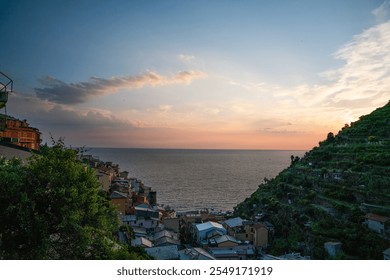 Sunset view over the ocean and charming hillside village in Cinque Terre, Italy. A serene and picturesque Mediterranean landscape showcasing the beauty of the Italian Riviera. - Powered by Shutterstock