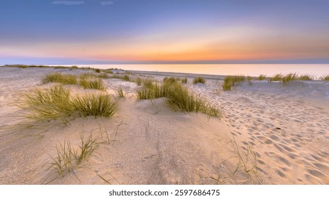 Sunset View over ocean from dune over North Sea and Canal in Ouddorp, Zeeland Province, the Netherlands. Outdoor scene of coast in nature of Europe.
