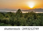 Sunset view over Polyfytos artificial lake, Servia Neraida bridge and Velventos village. Larissa, Greece.