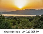 Sunset view over Polyfytos artificial lake and Velventos village. Larissa, Greece.