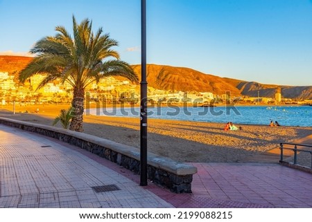 Sunset view of Playa de las Vistas at Tenerife, Canary islands, Spain.