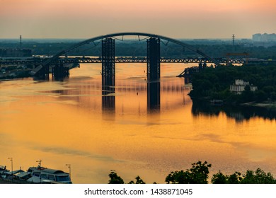 Sunset, View Of The Rusty Unfinished Bridge In Kiev, Ukraine. Known For Its Unusual Design And Very Beautiful And Unusual Bridge Is Popular Among Tourists. Concept, Tourism, Travel.