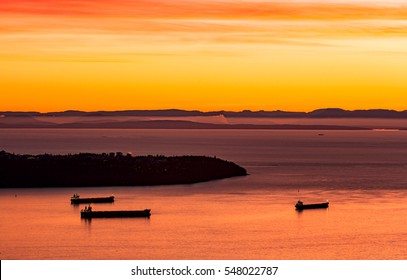 Sunset view of Salish Sea and Point Grey with moored cargo ships, Vancouver, British Columbia, Canada - Powered by Shutterstock