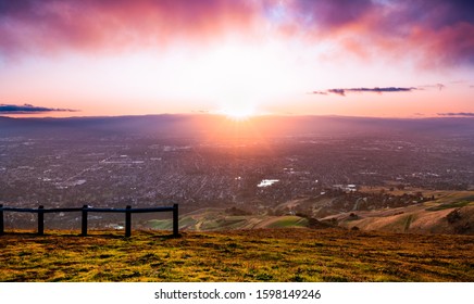 Sunset view of San Jose, part of Silicon Valley; hills starting to turn green visible in the foreground; San Francisco Bay Area, California