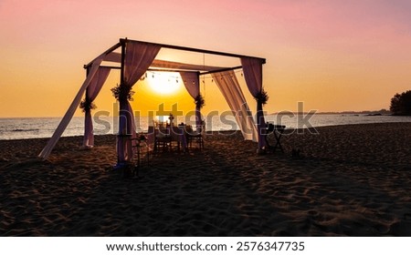 The sunset view scene with romantic dinner set up on the beach