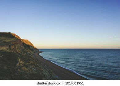 Sunset view of the sea and cliffs with beach. Travel inspiration