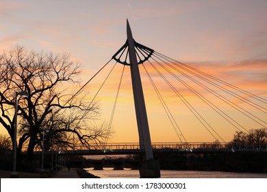 A sunset view of south bridge span of The Keeper of the Plains Bridge over the Arkansas River in Wichita, Kansas