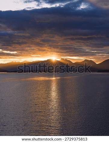 Sunset View Strait of Magellan Ship in the Distance. Golden Sunlit Flare Over Mountains Incredible Landscape Scenic Channel South America