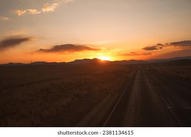 Sunset view through the bus window of a road through the highlands of Peru