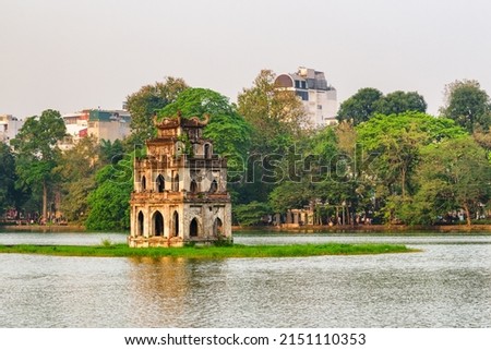 Sunset view of the Turtle Tower in middle of the Hoan Kiem Lake (Lake of the Returned Sword) at historic centre of Hanoi in Vietnam. The Turtle Tower is a popular tourist attraction of Asia.