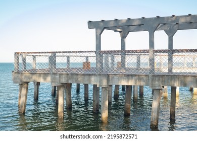 Sunset Viewpoint In Kartini Beach, Indonesia. Beach Bridge In The Port.