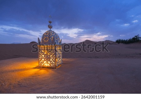 Sunset views of lanterns lit up I the dark at a desert camp in Erg Chebbi sand dunes located in Morocco on the western edge of the Sahara Desert