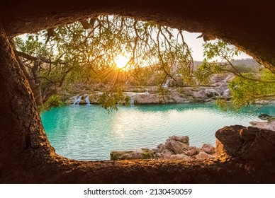 Sunset in Wadi Darbat as the  sunbeams shining through the trunks of trees, Oman. - Shutterstock ID 2130450059