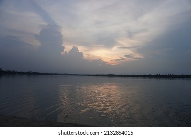 Sunset With Water Reflection And Still Water Surface