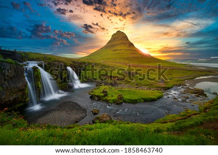 Sunset waterfall with big stones in Iceland