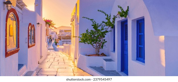 Sunset with white churches and blue domes by the ocean of Oia Santorini Greece. - Powered by Shutterstock