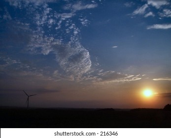 sunset with wind turbine