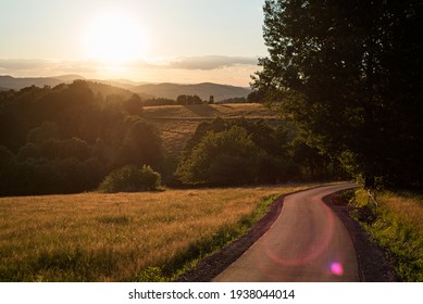 sunset. A winding road leading into the sunset. Mountain landscape