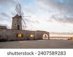 Sunset at Windmills in the salt evoporation pond in Marsala, Sicily island, Italy
Trapani salt flats and old windmill in Sicily.
View in beautifull sunny day.