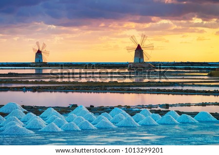 Sunset at Windmills in the salt evoporation pond in Marsala, Sicily island, Italy