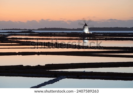 Sunset at Windmills in the salt evoporation pond in Marsala, Sicily island, Italy
Trapani salt flats and old windmill in Sicily.
View in beautifull sunny day.